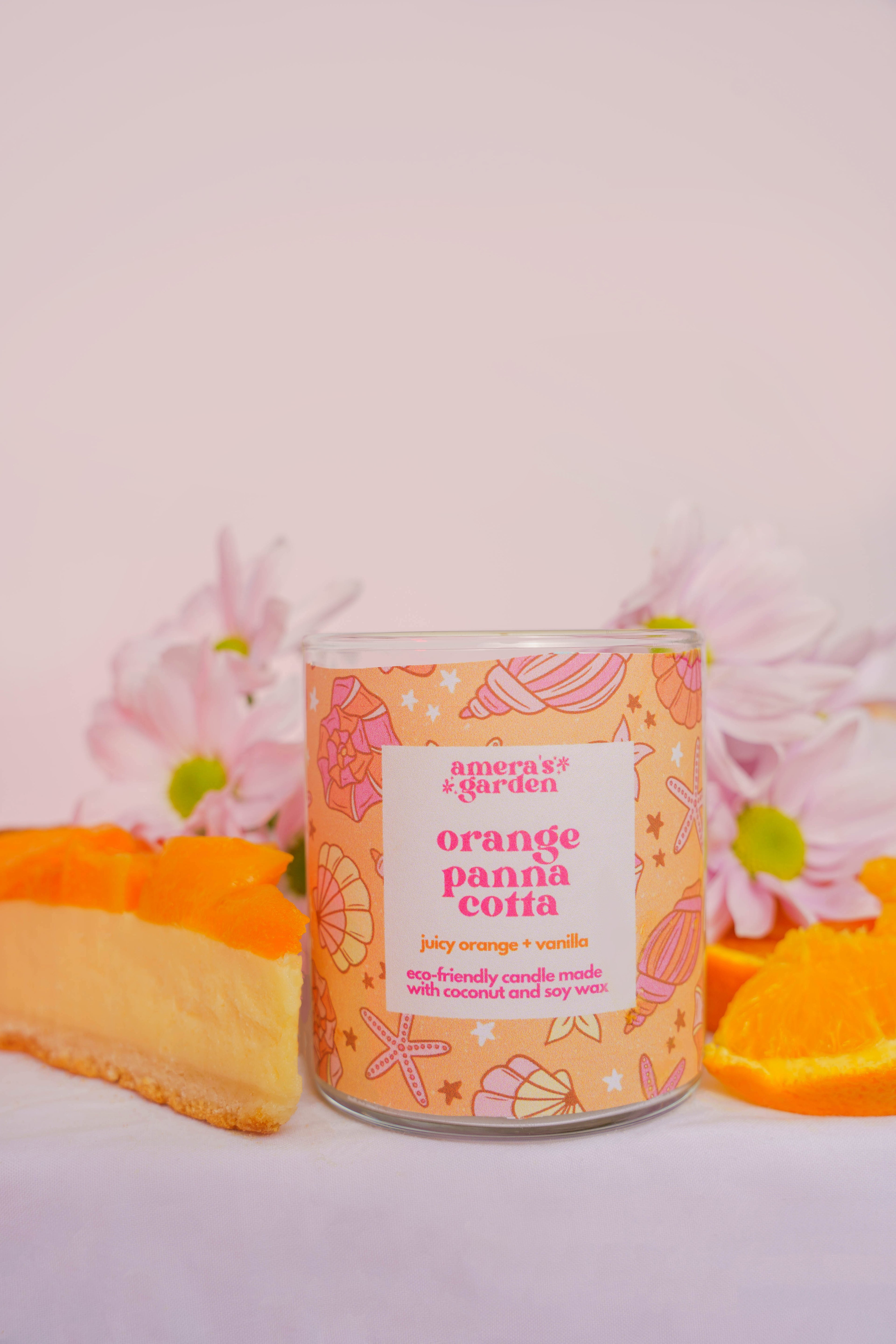 orange panna cotta candle by amera's garden. Orange slice and floweres in background